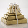 5 gold chocolate boxes stacked up on top of each other with a ribbon tying it together.